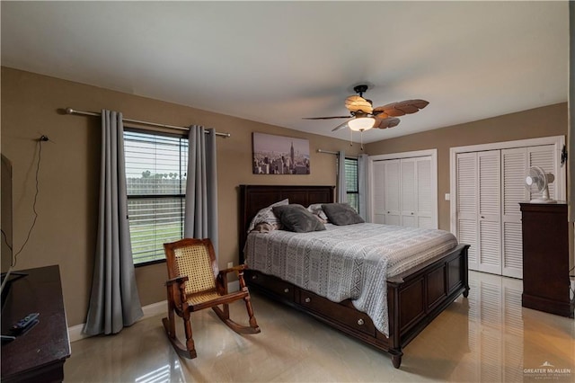 bedroom featuring ceiling fan and two closets