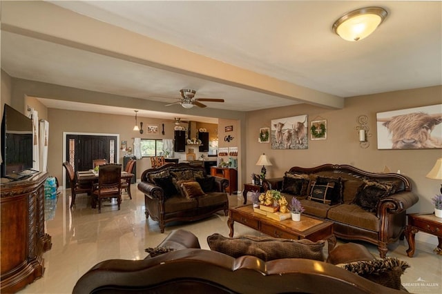 living room featuring beamed ceiling and ceiling fan