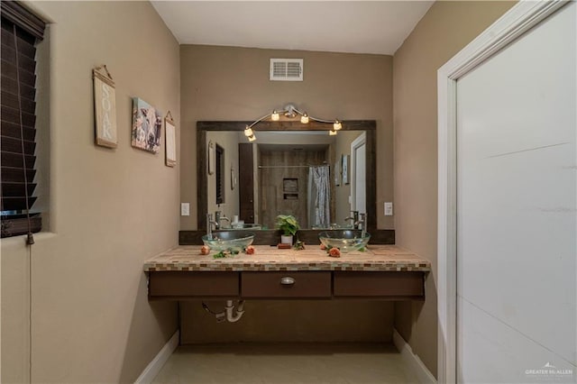 bathroom featuring vanity and curtained shower