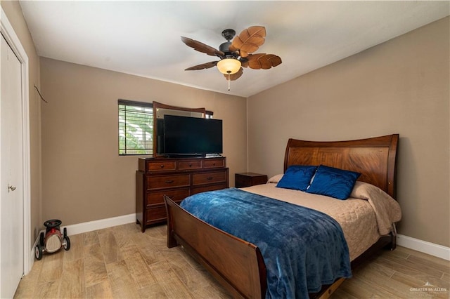 bedroom with ceiling fan, a closet, and light hardwood / wood-style floors