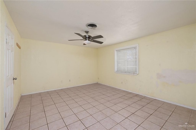 unfurnished room with ceiling fan and light tile patterned floors