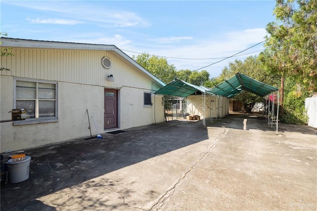 exterior space with a storage unit and a carport