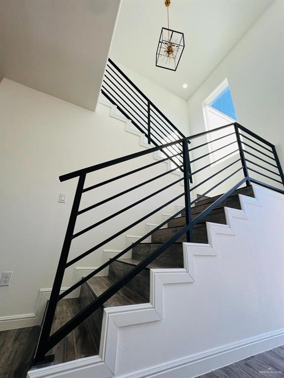 staircase featuring wood-type flooring