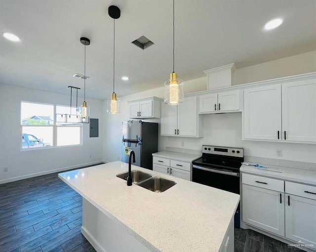 kitchen with sink, white cabinetry, hanging light fixtures, stainless steel fridge, and a kitchen island with sink