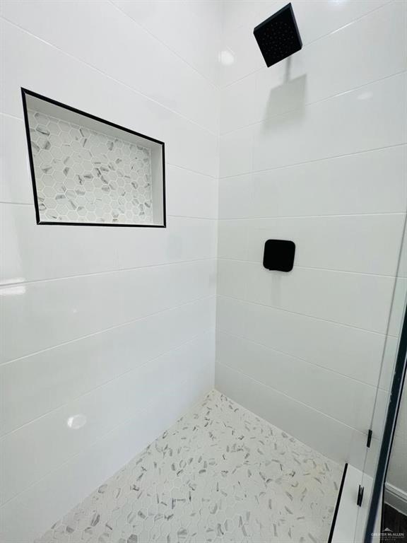 bathroom with a tile shower