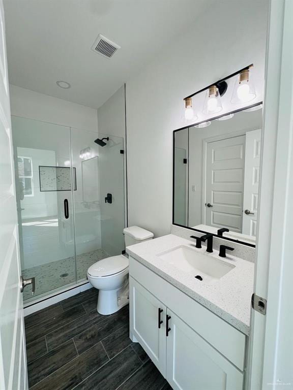 bathroom with vanity, a baseboard heating unit, toilet, and walk in shower