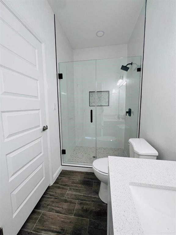 bathroom with vanity, toilet, and walk in shower