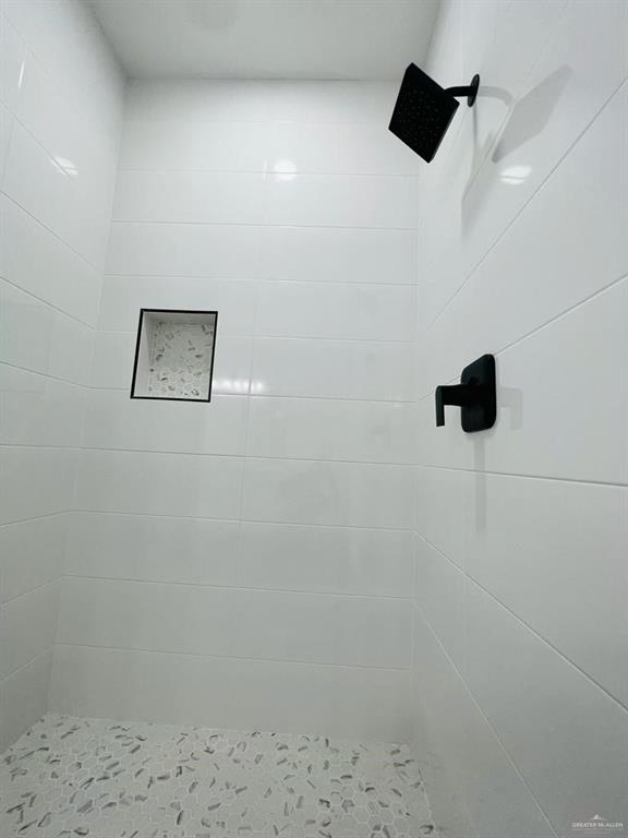 bathroom with a tile shower