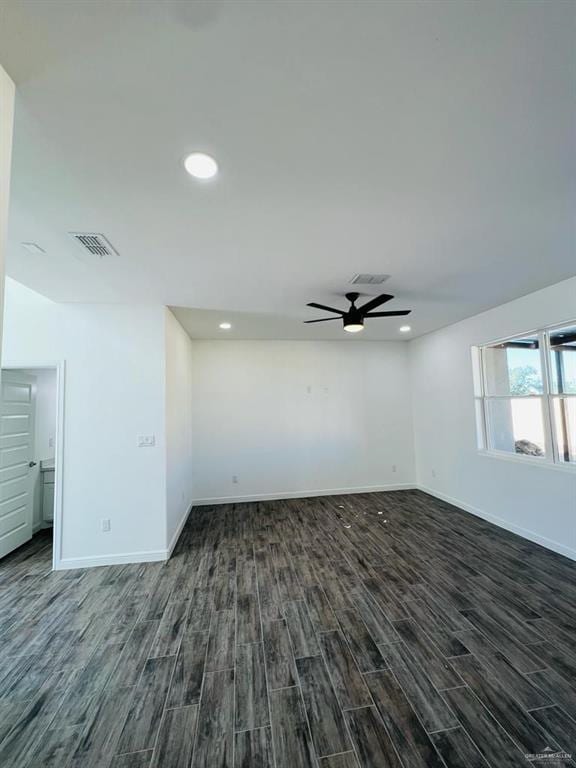 empty room featuring ceiling fan and dark hardwood / wood-style flooring