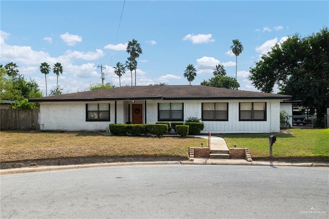 ranch-style home with a front lawn