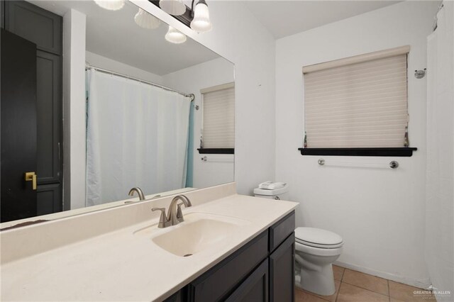 bathroom with tile patterned floors, vanity, and toilet