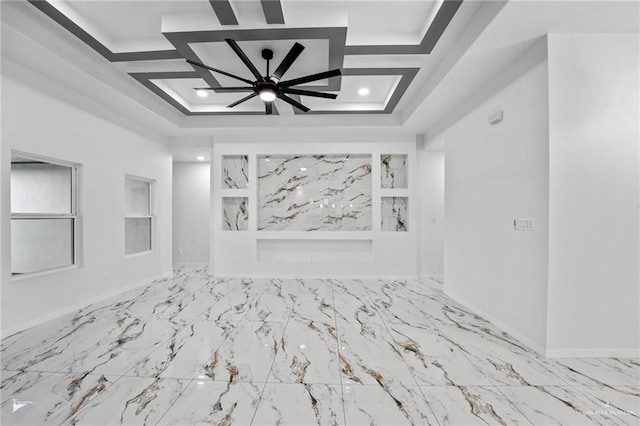 unfurnished room with a raised ceiling and ceiling fan