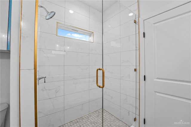 bathroom with an enclosed shower and toilet