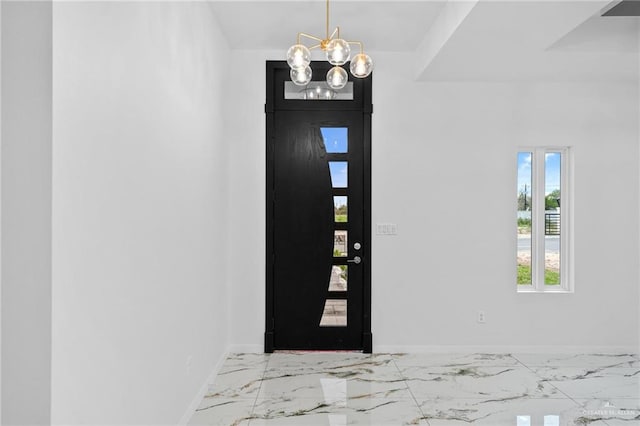 foyer entrance with a healthy amount of sunlight and a notable chandelier