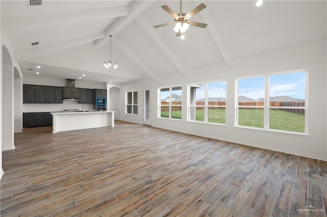 14724 Aqualina Way, Mcallen, TX 78504 - unfurnished living room with beamed ceiling, a ceiling fan, light wood finished floors, recessed lighting, and arched walkways