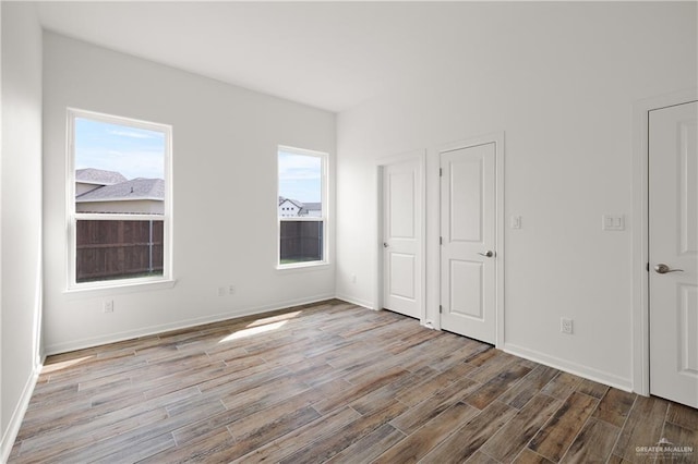 14724 Aqualina Way, Mcallen, TX 78504 - unfurnished bedroom with wood finished floors and baseboards