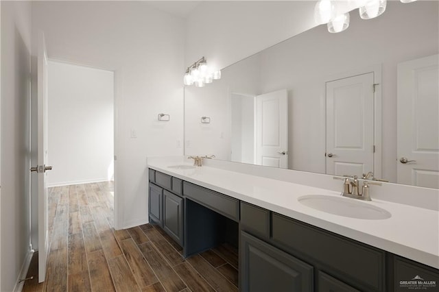14724 Aqualina Way, Mcallen, TX 78504 - full bathroom with double vanity, wood finished floors, and baseboards