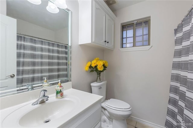 bathroom featuring toilet, vanity, and tile patterned floors