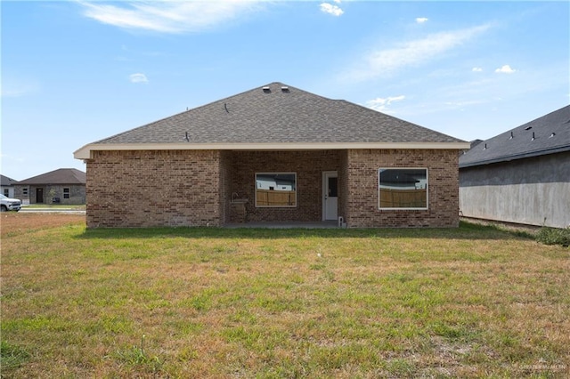 rear view of house with a lawn