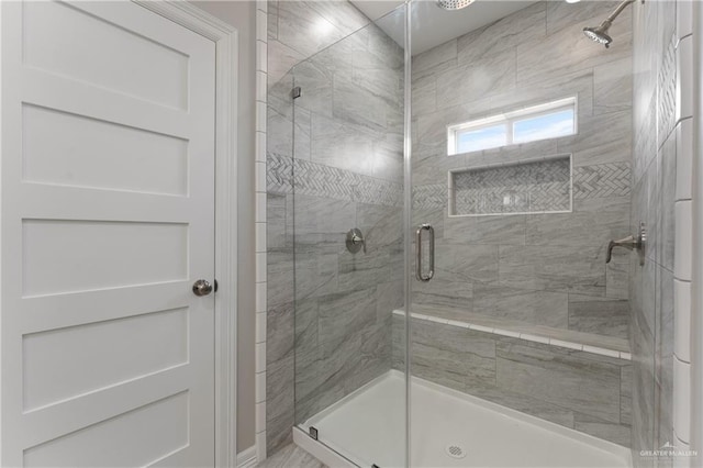 bathroom with a shower with door