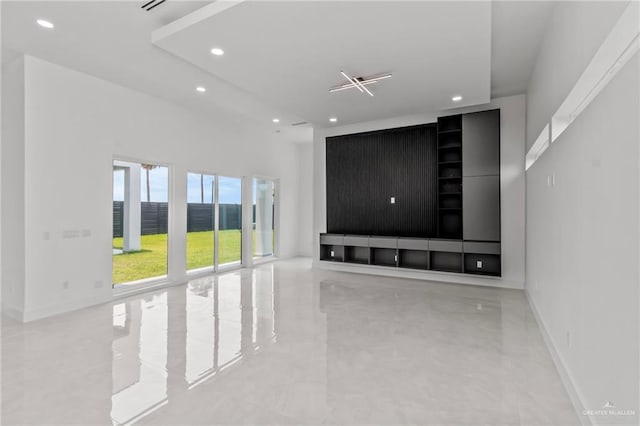 unfurnished living room featuring baseboards and recessed lighting