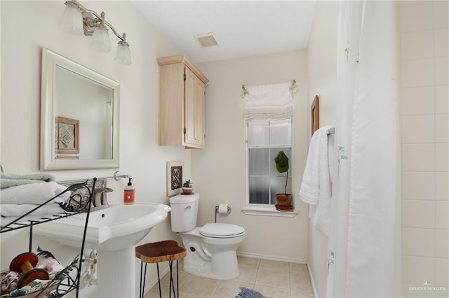 bathroom featuring tile patterned flooring and toilet