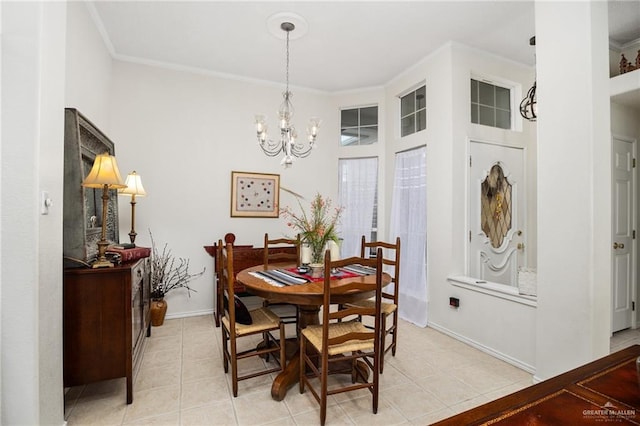 dining space with light tile patterned floors, crown molding, and an inviting chandelier