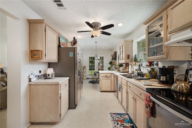 kitchen with ceiling fan, sink, stainless steel appliances, light brown cabinetry, and light tile patterned floors