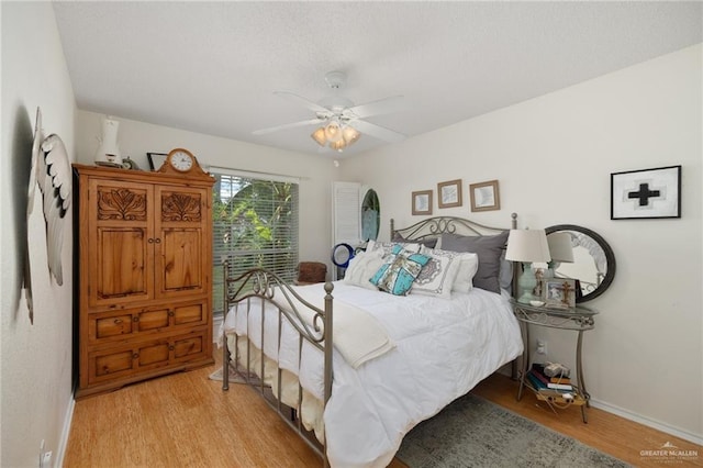 bedroom with ceiling fan and light hardwood / wood-style flooring