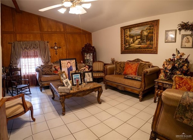 living room featuring light tile patterned floors, vaulted ceiling, ceiling fan, and wood walls