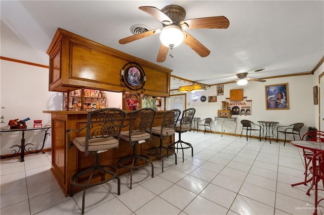 15668 Primera Rd, Harlingen, TX 78552 - indoor dry bar featuring a ceiling fan, light tile patterned floors, ornamental molding, and baseboards