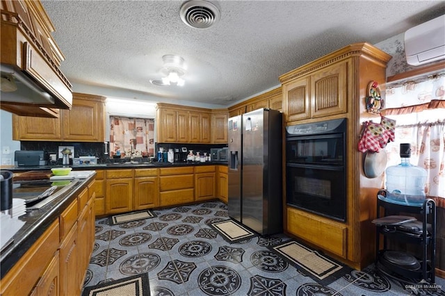 15668 Primera Rd, Harlingen, TX 78552 - kitchen with black appliances, a wall mounted AC, a sink, dark countertops, and a textured ceiling