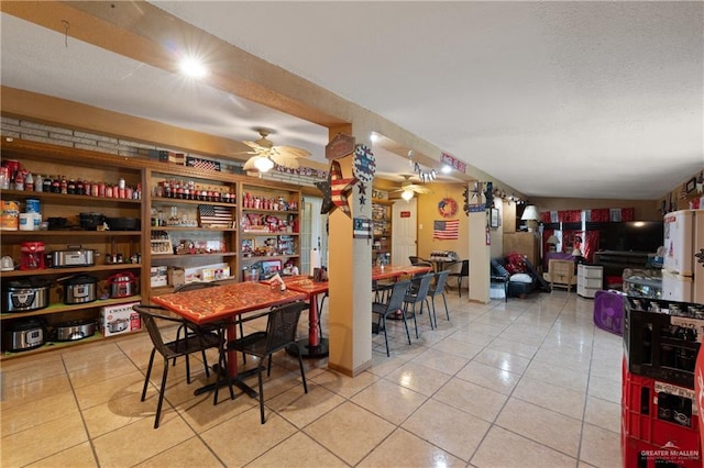 15668 Primera Rd, Harlingen, TX 78552 - dining space with light tile patterned floors, a ceiling fan, and a textured ceiling