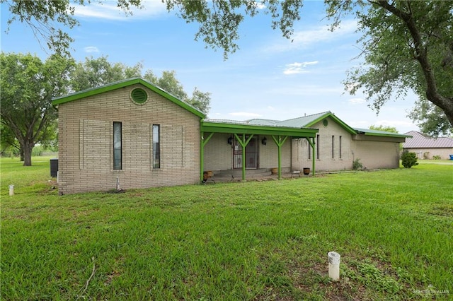 15668 Primera Rd, Harlingen, TX 78552 - ranch-style house with a front yard, brick siding, and covered porch