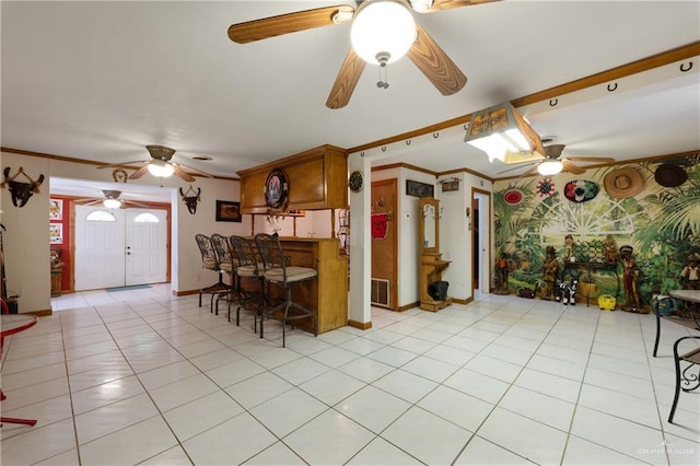 15668 Primera Rd, Harlingen, TX 78552 - kitchen with ceiling fan, ornamental molding, baseboards, light tile patterned floors, and brown cabinets