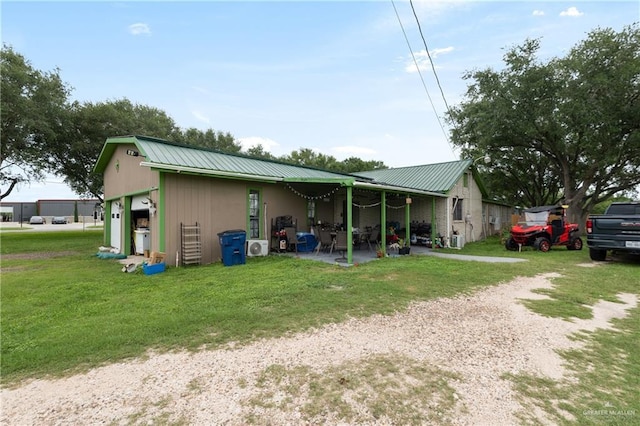 15668 Primera Rd, Harlingen, TX 78552 - back of property featuring metal roof and a lawn