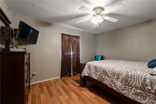 15668 Primera Rd, Harlingen, TX 78552 - bedroom with light wood finished floors, baseboards, and ceiling fan