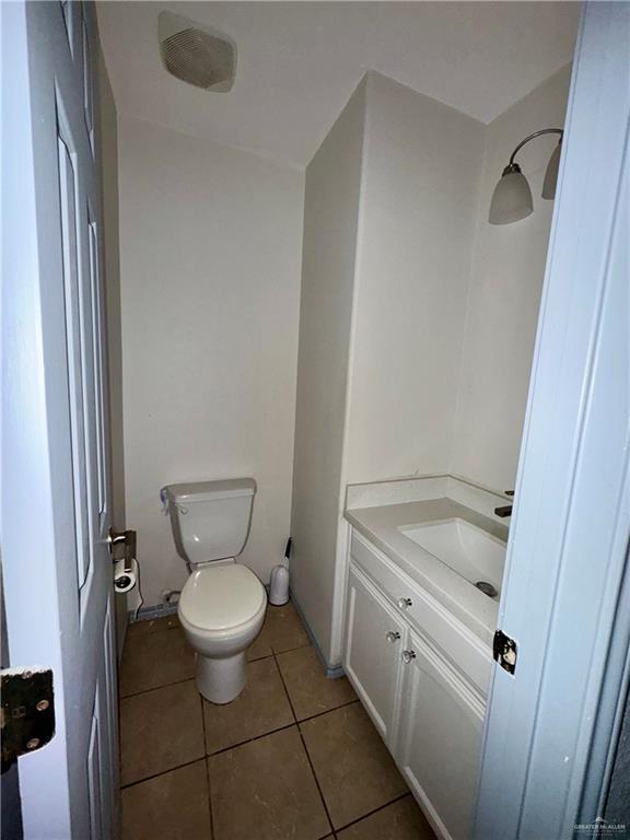 bathroom with vanity, tile patterned floors, and toilet