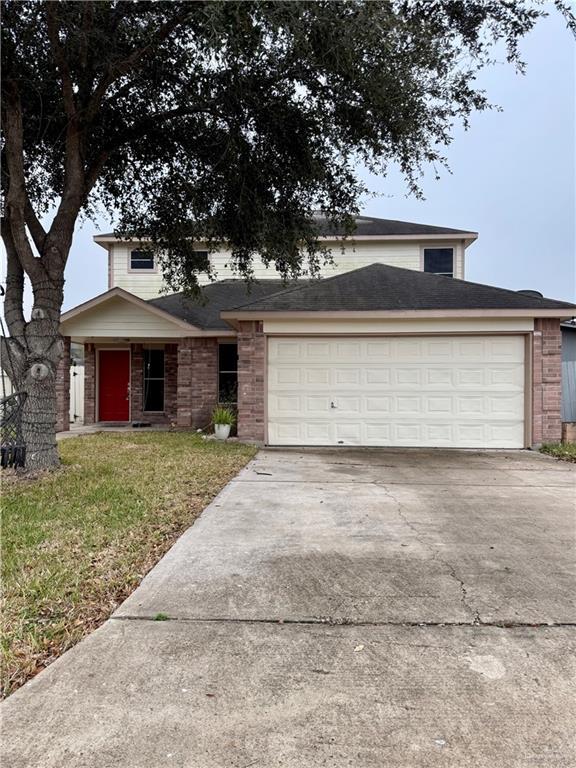 view of front of house featuring a garage and a front lawn