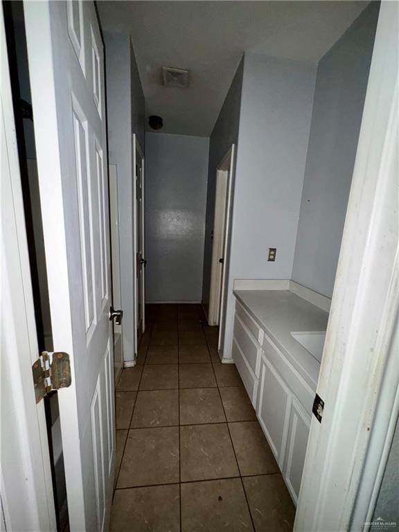 bathroom with tile patterned flooring and vanity