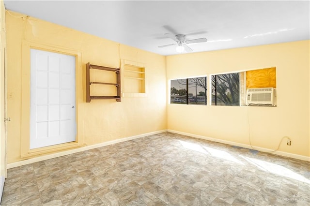 spare room with cooling unit, a ceiling fan, and baseboards