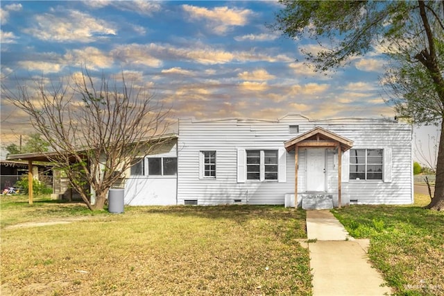 view of front of home featuring a front yard and crawl space