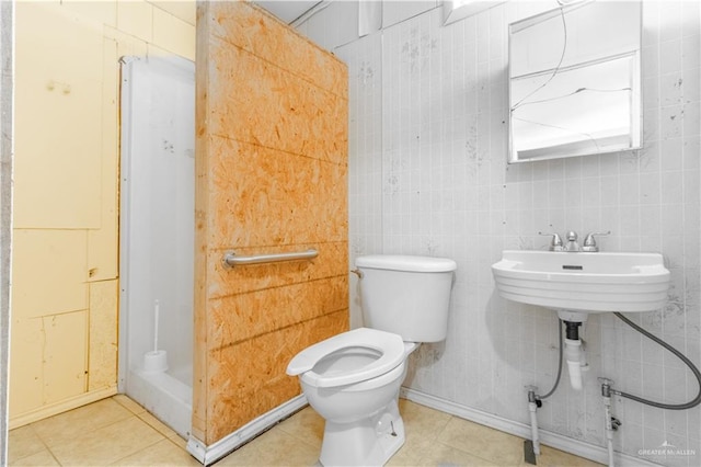 full bathroom with tile patterned floors, toilet, and a stall shower