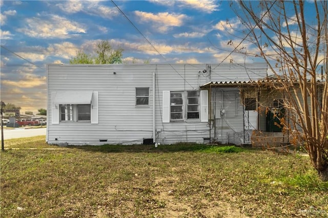 back of house with a yard and crawl space