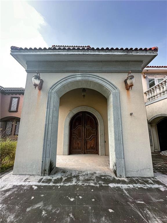 4132 Cosentino Dr, Mcallen, TX 78504 - view of exterior entry with stucco siding and a balcony