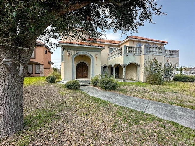4132 Cosentino Dr, Mcallen, TX 78504 - mediterranean / spanish home with a balcony, a tiled roof, stucco siding, and a front yard