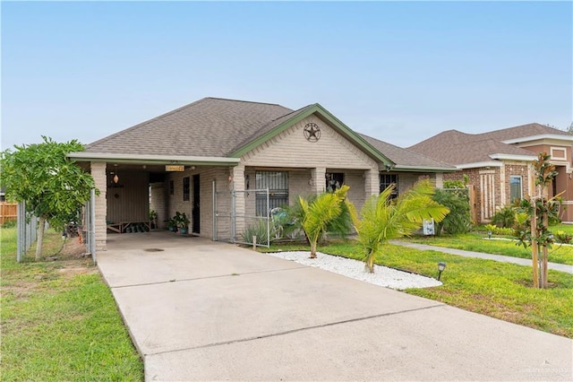 view of front of house with a carport and a front lawn