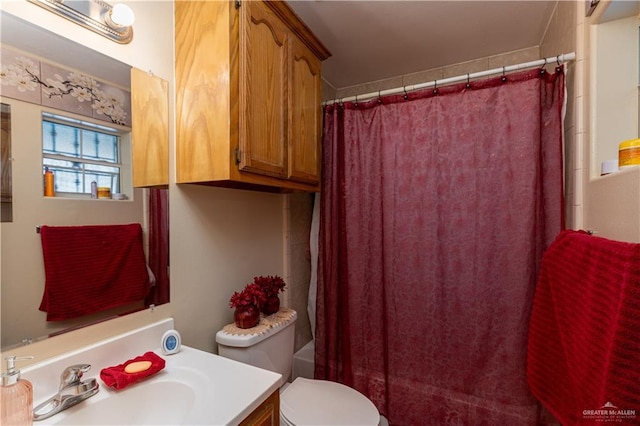 full bathroom with vanity, toilet, and shower / bath combo with shower curtain