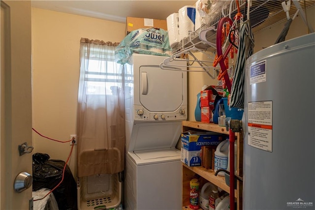 clothes washing area with stacked washer / drying machine and water heater