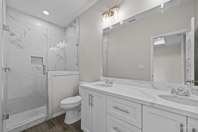 bathroom with vanity, toilet, and walk in shower